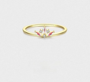 Close-up of crown ring with marquise red stone and white diamonds on gold band