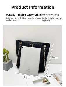 Detail of black woven tote bag with gold chain strap and spacious interior for iPad