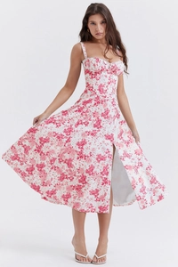 Detail of a pink floral camisole dress featuring a corset bodice and a high side slit