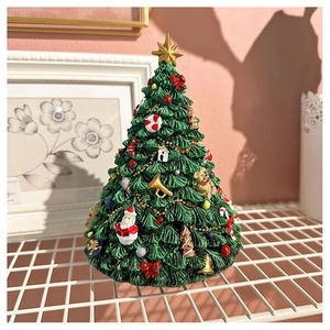Close-up of a festive Christmas tree music box featuring intricate 3D holiday ornaments