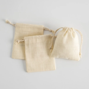 Detailed view of beige cotton drawstring pouches with natural textured fiber fabric