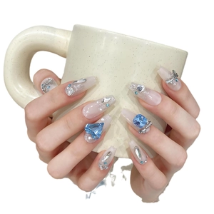 Handmade ballerina press-on nails with blue heart gems and silver bows on white base