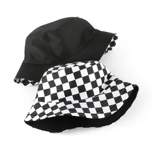Detailed view of reversible cotton bucket hat featuring black solid and checkered pattern