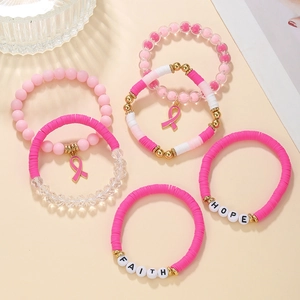 Detail of pink beaded bracelets set with Faith and Hope acrylic charms and soft clay beads