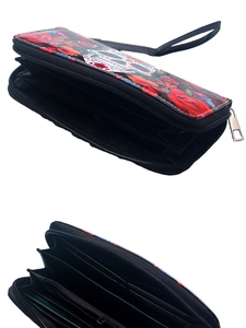 Macro view showing internal card slots and zipper compartment of the skull floral wallet