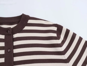 Detail of round ribbed neckline and buttons on brown and beige striped knit cardigan