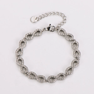 Detailed macro view of silver infinity bracelet with pavé-set white zirconias and S.steel logo