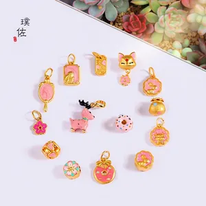Fashionable gold plated necklaces with pink enamel animal and floral charms