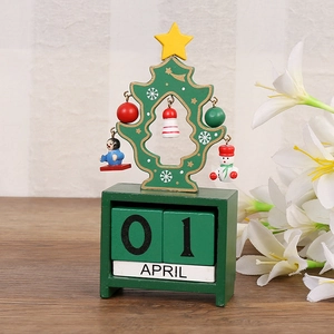Close-up of wooden Christmas tree calendar with festive ornaments and date blocks
