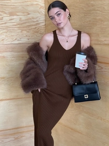 Close-up of brown ribbed knit maxi dress paired with a matching faux fur jacket