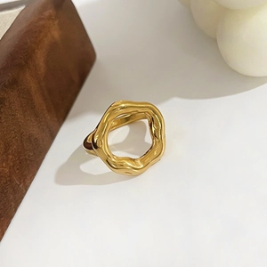 Detailed close-up of 18K gold irregular wavy ring featuring modern lava texture on white background