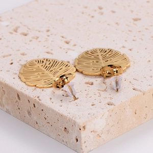 French vintage gold leaf earrings with textured monstera hollow pattern on stone base