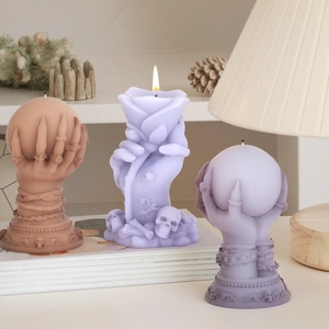 Detailed view of Halloween skull hand rose and ball scented candles with bone texture