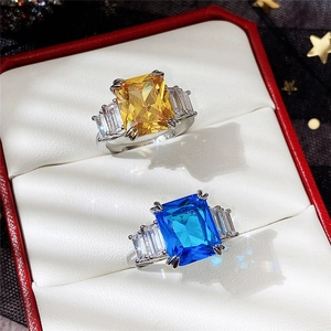 Macro detail of rectangle sapphire and yellow zircon rings with S925 silver finish