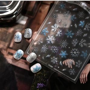 Macro detail of KX495 winter snowflake nail art stickers with blue and silver glitter finish