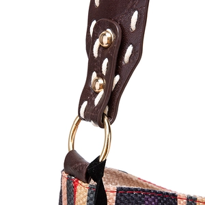 Detail of bohemian woven tote showing leather shoulder strap with white hand-stitching