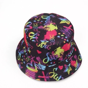 Close-up of neon graffiti skull prints and vibrant typography on a black bucket hat