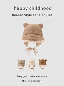 Detail of quilted winter trapper hats for kids with plush lining and bear ear accents