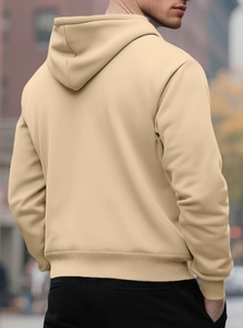 Rear view of beige oversized hoodie featuring ribbed hem and cuffs in street setting
