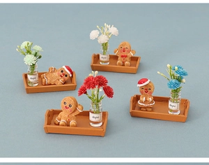 Miniature gingerbread man sets with dry flowers in glass Hope bottles on small trays