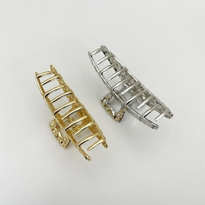 Set of large gold and silver woven alloy hair claw clips for thick hair styling