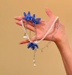 Exquisite detail view of handmade blue beaded flower and pearl jewelry necklace set