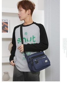 Detail of blue multi-pocket crossbody bag with waterproof fabric and durable shoulder strap