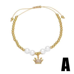 Gold-plated beaded bracelet with pearls, crown charm and zircon inlay on white background
