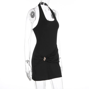 Detail of sexy black halter dress featuring side ruching and silver metal ring hardware