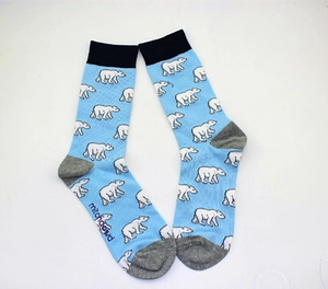 Detail view of light blue socks featuring polar bear patterns and tri-color knit design