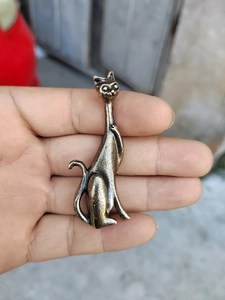 Macro shot of a vintage brass cat ring holder stand with a long neck and matte finish