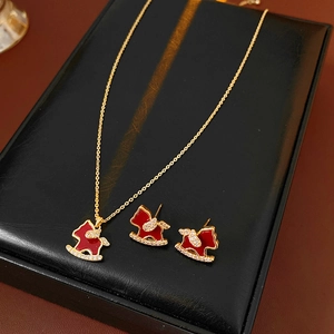 Gold plated jewelry set with red rocking horse pendant necklace and stud earrings