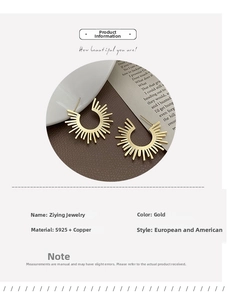 Detail view of golden sunburst fan-shaped earrings made of S925 silver and copper