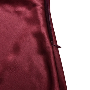 Detail of the high-quality invisible zipper on the elegant dark red satin evening dress