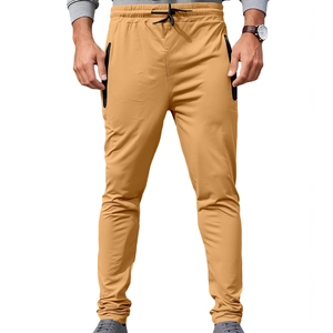 Men's khaki drawstring joggers with black zipper pockets and cuffed hem in a slim-fit cut