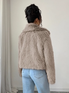 Back view of elegant beige faux fur coat showing soft texture and premium quality