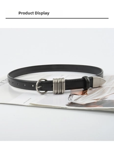 Detail of slim black leather belt with silver pin buckle and five metallic ring loops
