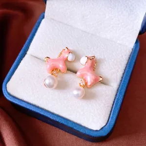 Elegant 18K gold plated pony earrings with pearls and pink enamel on silk background