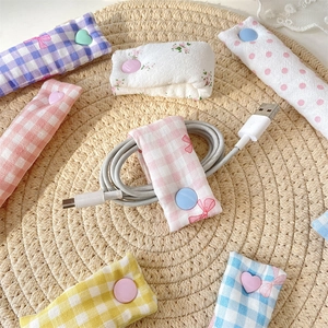 Cute floral and plaid fabric cable organizers with snaps for tidy wire management