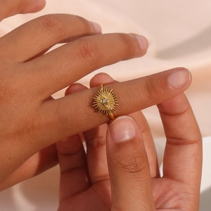 Macro view of gold plated evil eye ring with cubic zirconia on silk fabric