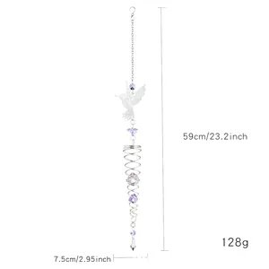 Detail of crystal suncatcher with hummingbird pendant and spiral metal frame