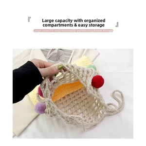 Detail view showing large interior capacity of hollow knit tote bag with colorful pom-poms