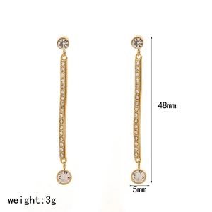Detail view showing 48mm gold tassel earrings with sparkling crystals and drop design