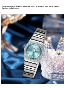 Detailed macro view of the silver metal strap and light blue sunburst dial with crystals