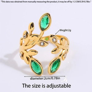 Detail view of golden leaf ring with green gemstones including size and weight specs