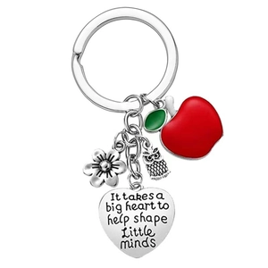 Detail of teacher appreciation keychain with red apple charm and engraved heart pendant
