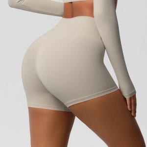 Detail view of high waisted seamless yoga shorts featuring peach lift and oatmeal fabric