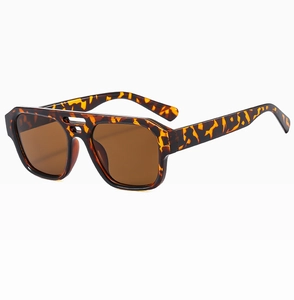 Detail view of tortoiseshell sunglasses with double bridge frame and brown lenses