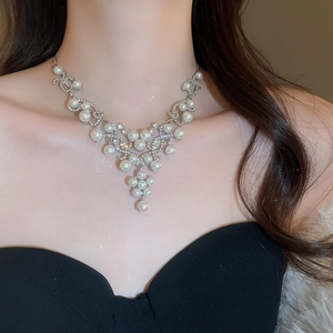 Close-up of French vintage necklace featuring waterdrop pearls and sparkling rhinestones