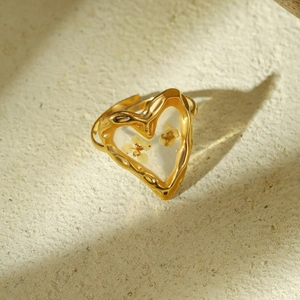 Golden heart-shaped open ring with dried flower inlay and lava textured edges
